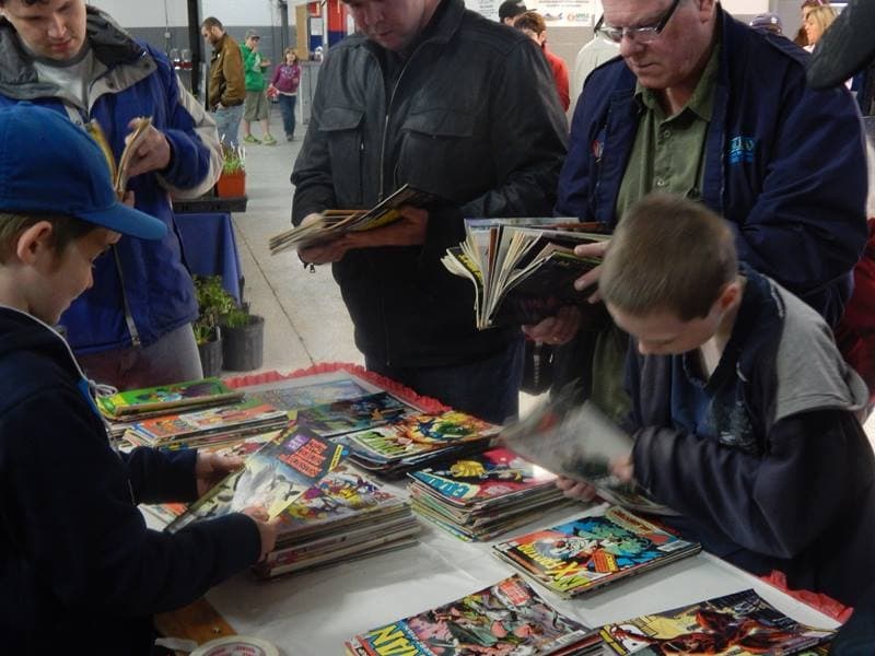 Shoppers digging through boxes of comics at a past World's Largest Garage Sale event
