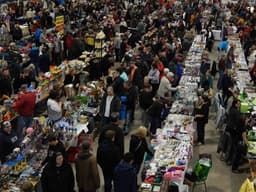 Shoppers browsing crowded vendor tables at a past World's Largest Garage Sale event